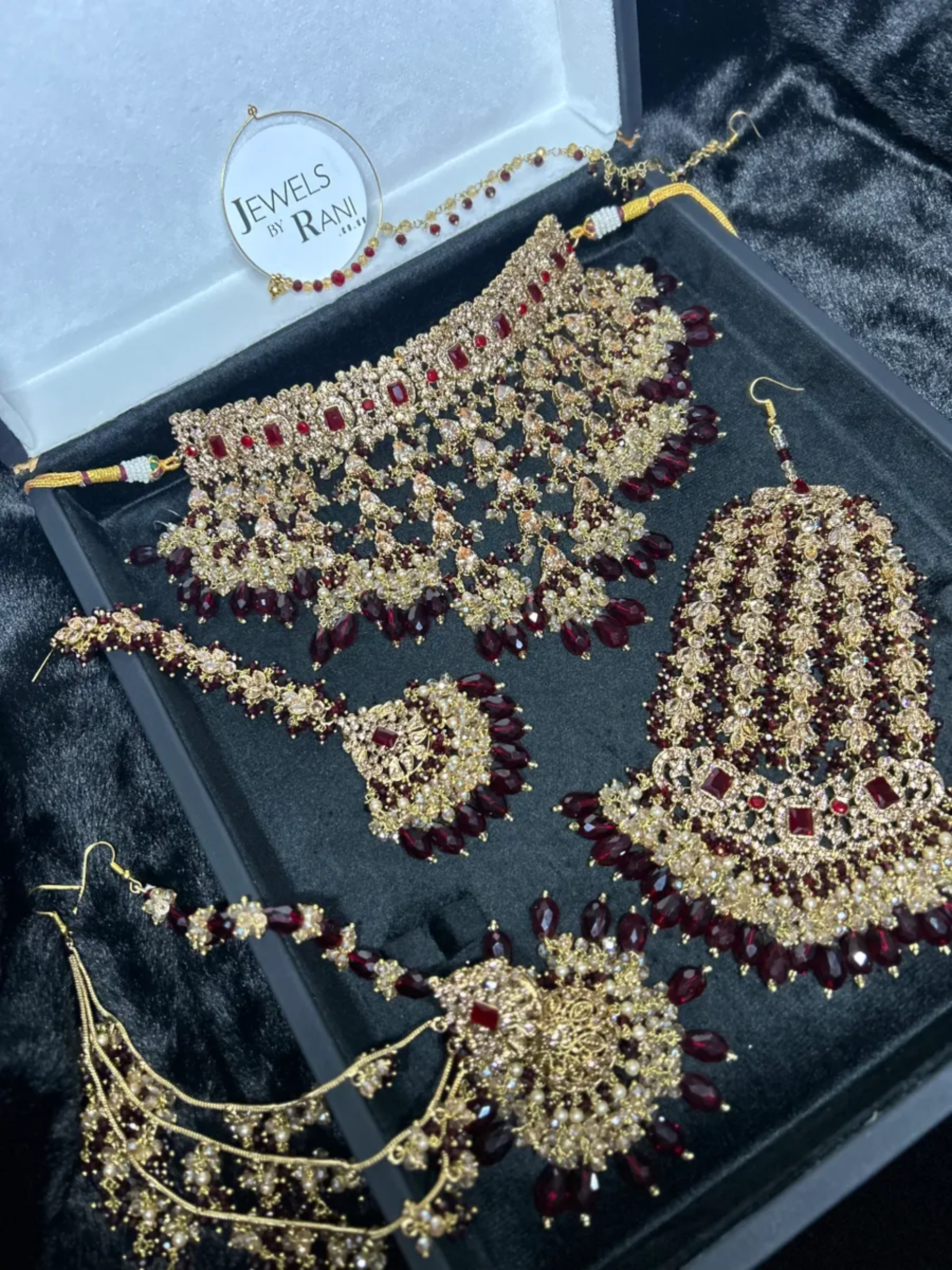 Pre Order 6 Week: Trending Dangled Crystal Maroon 24 crt Gold Plated Bridal Jewellery Set