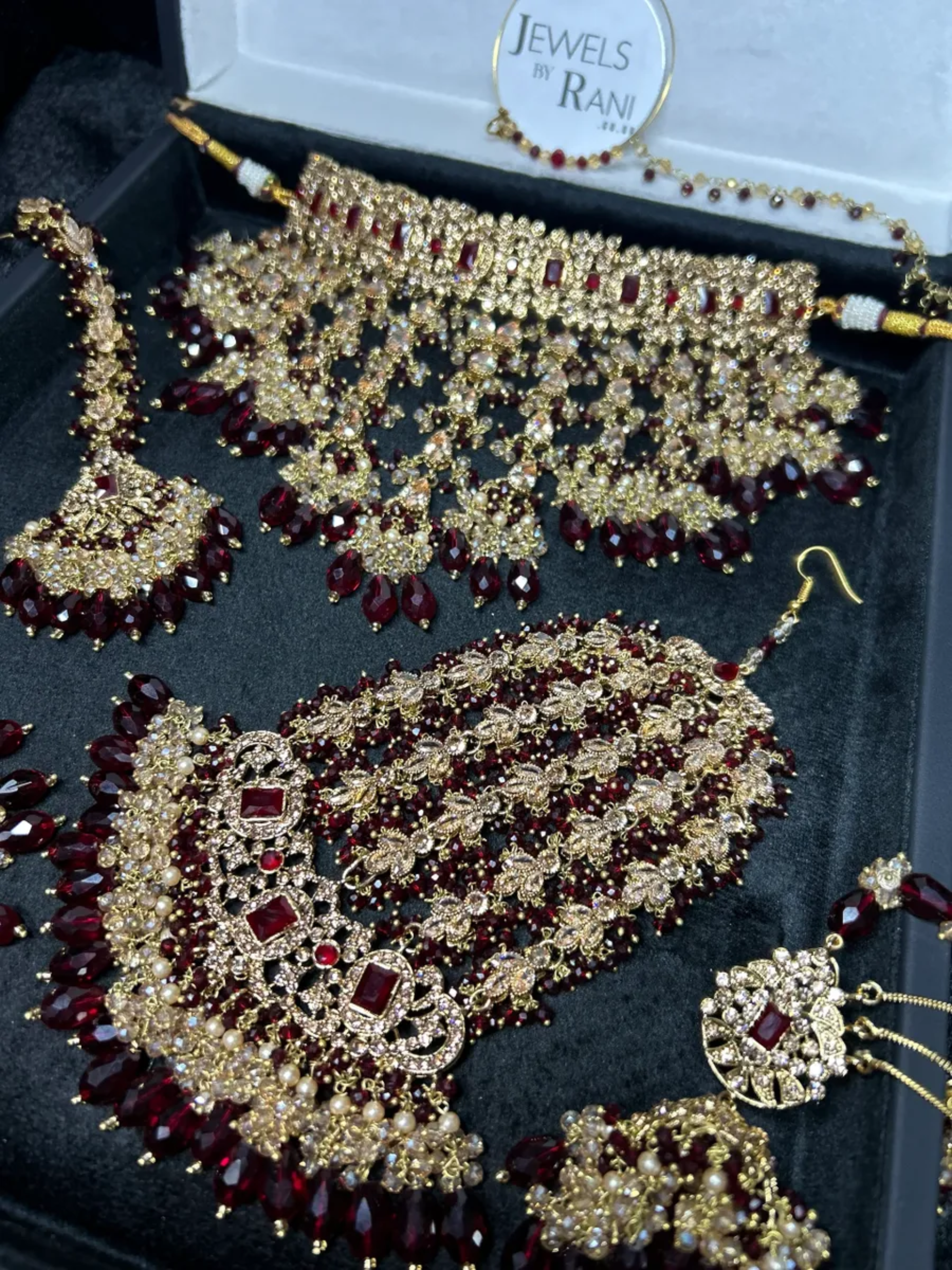 Pre Order 6 Week: Trending Dangled Crystal Maroon 24 crt Gold Plated Bridal Jewellery Set