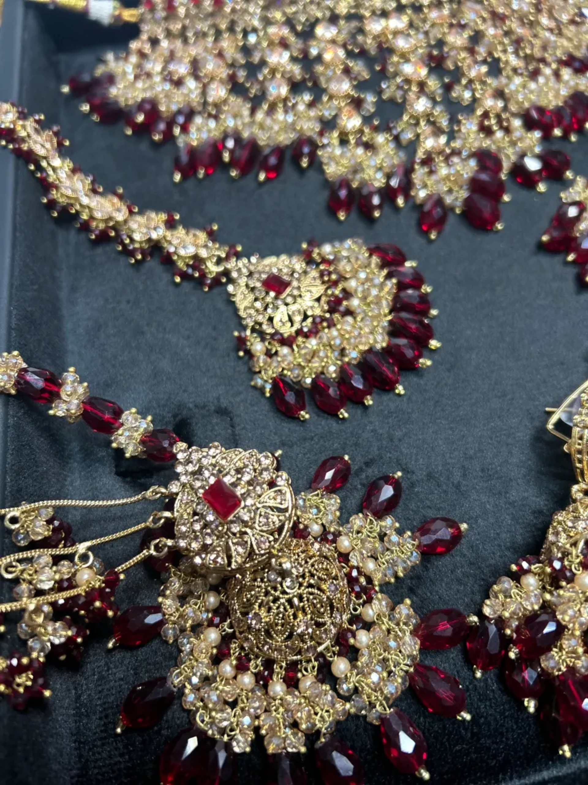 Pre Order 6 Week: Trending Dangled Crystal Maroon 24 crt Gold Plated Bridal Jewellery Set