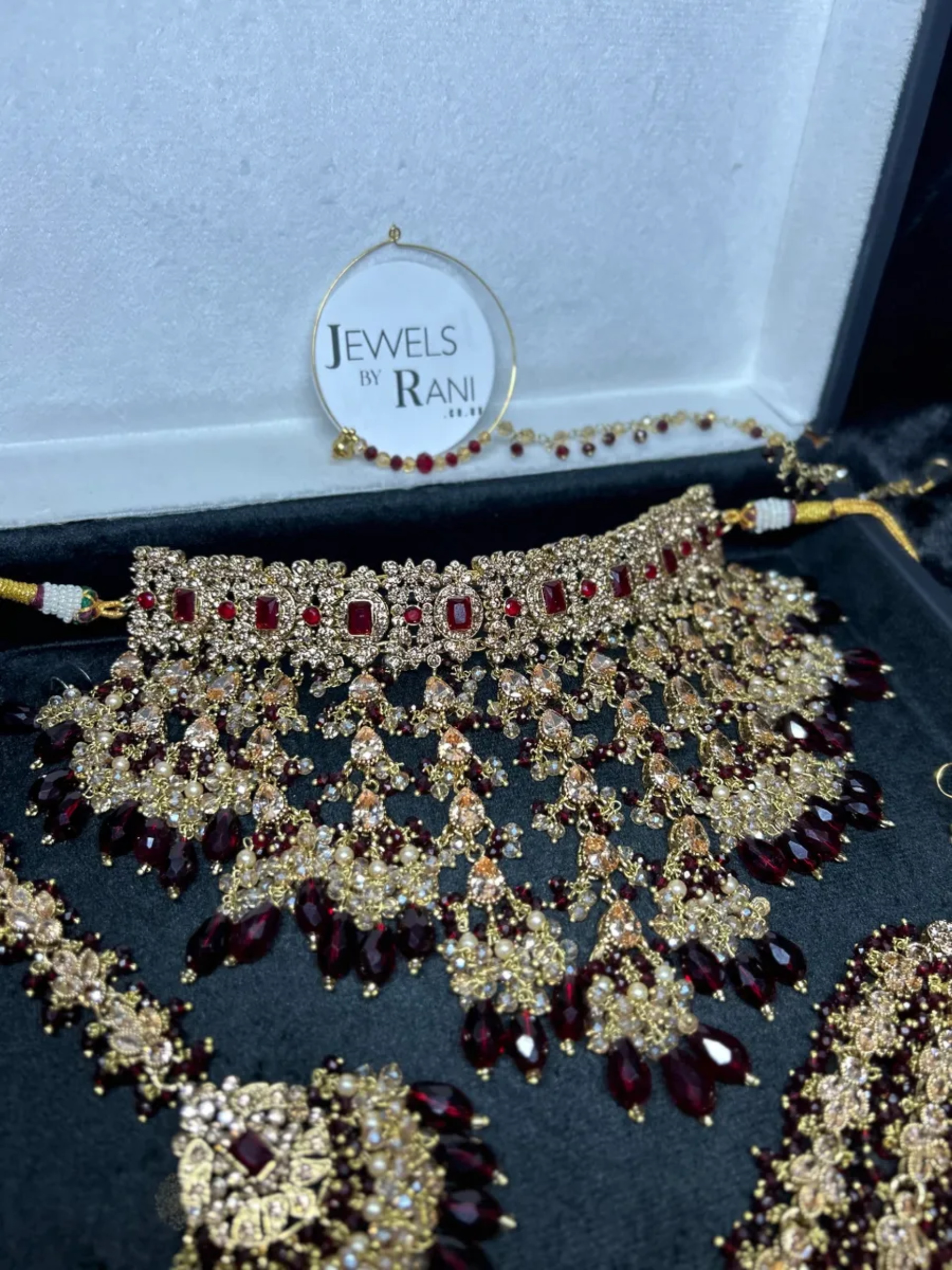 Pre Order 6 Week: Trending Dangled Crystal Maroon 24 crt Gold Plated Bridal Jewellery Set