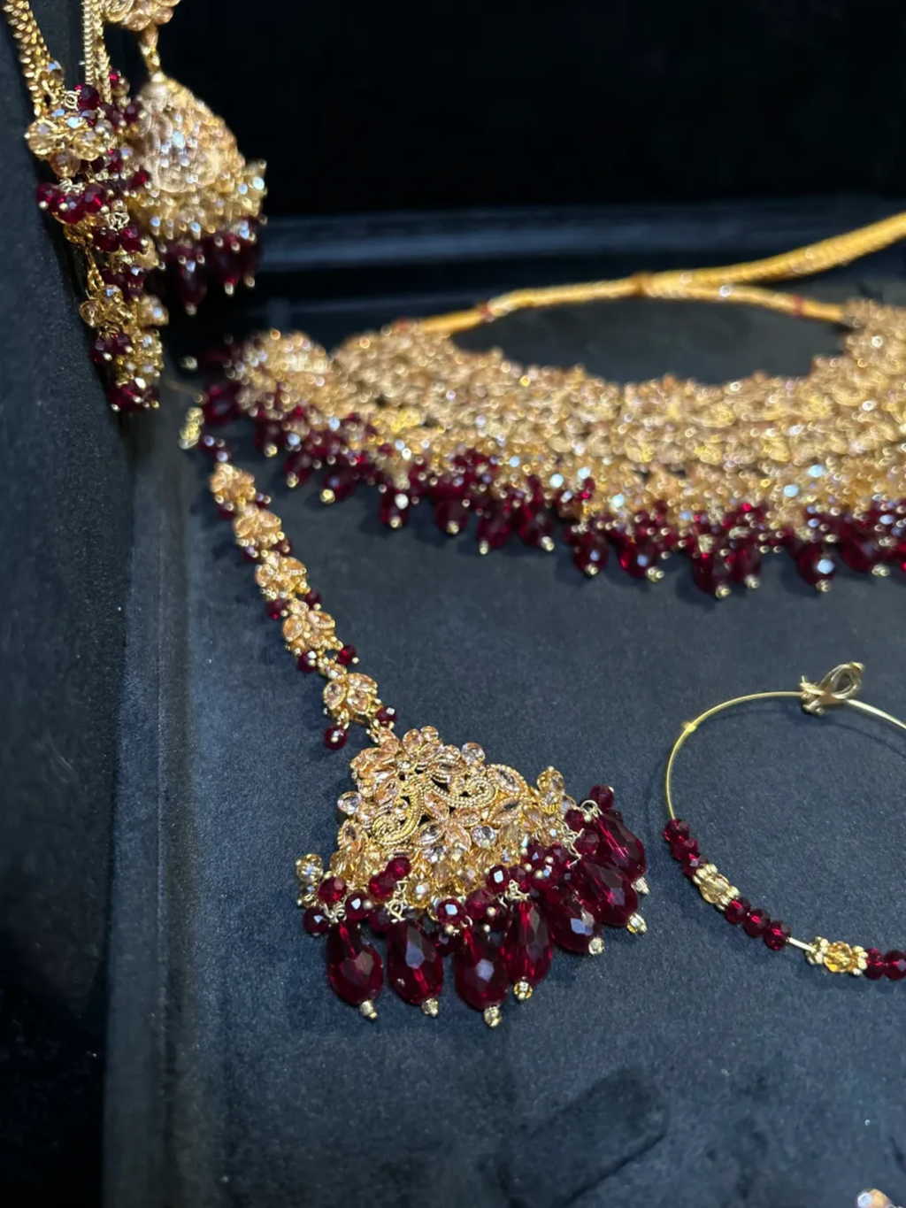 Luxury Maroon Crystals & Gold set, with heavily beaded earrings & tikka. - Jewelsbyrani