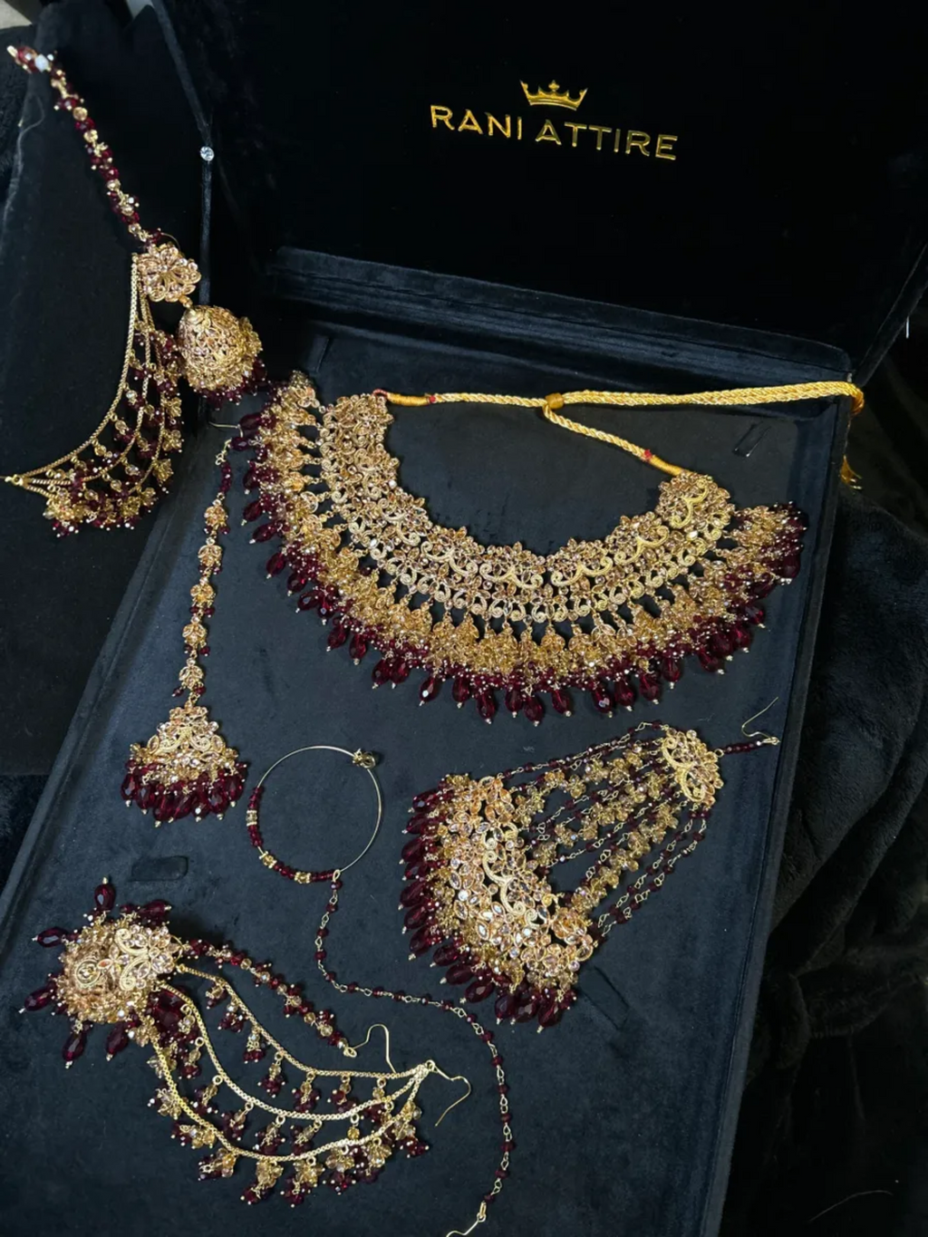 Luxury Maroon Crystals & Gold set, with heavily beaded earrings & tikka. - Jewelsbyrani