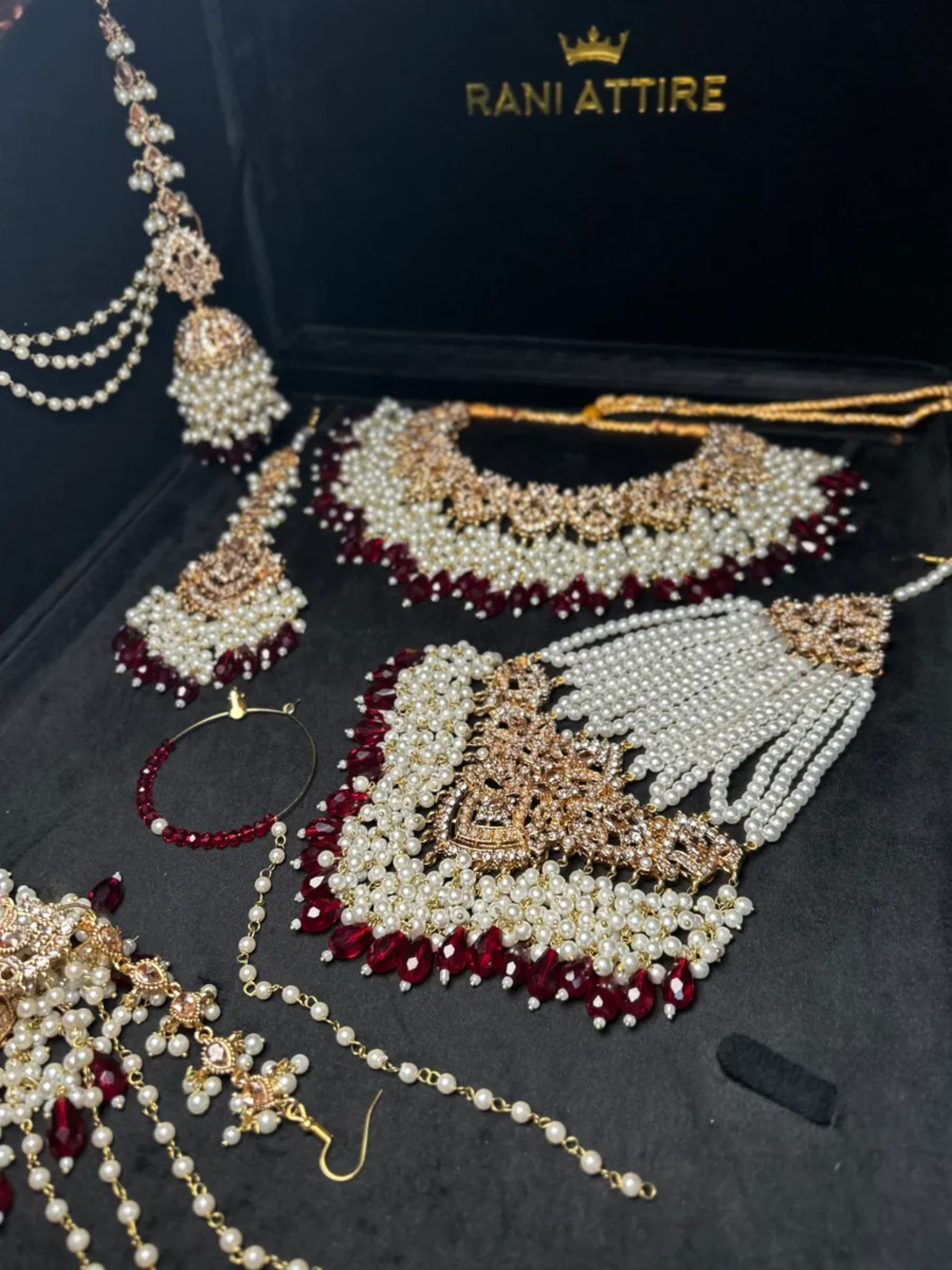Gold and white necklace with Maroon Crystals + Gold Stones, with heavily beaded earrings & tikka - Jewelsbyrani