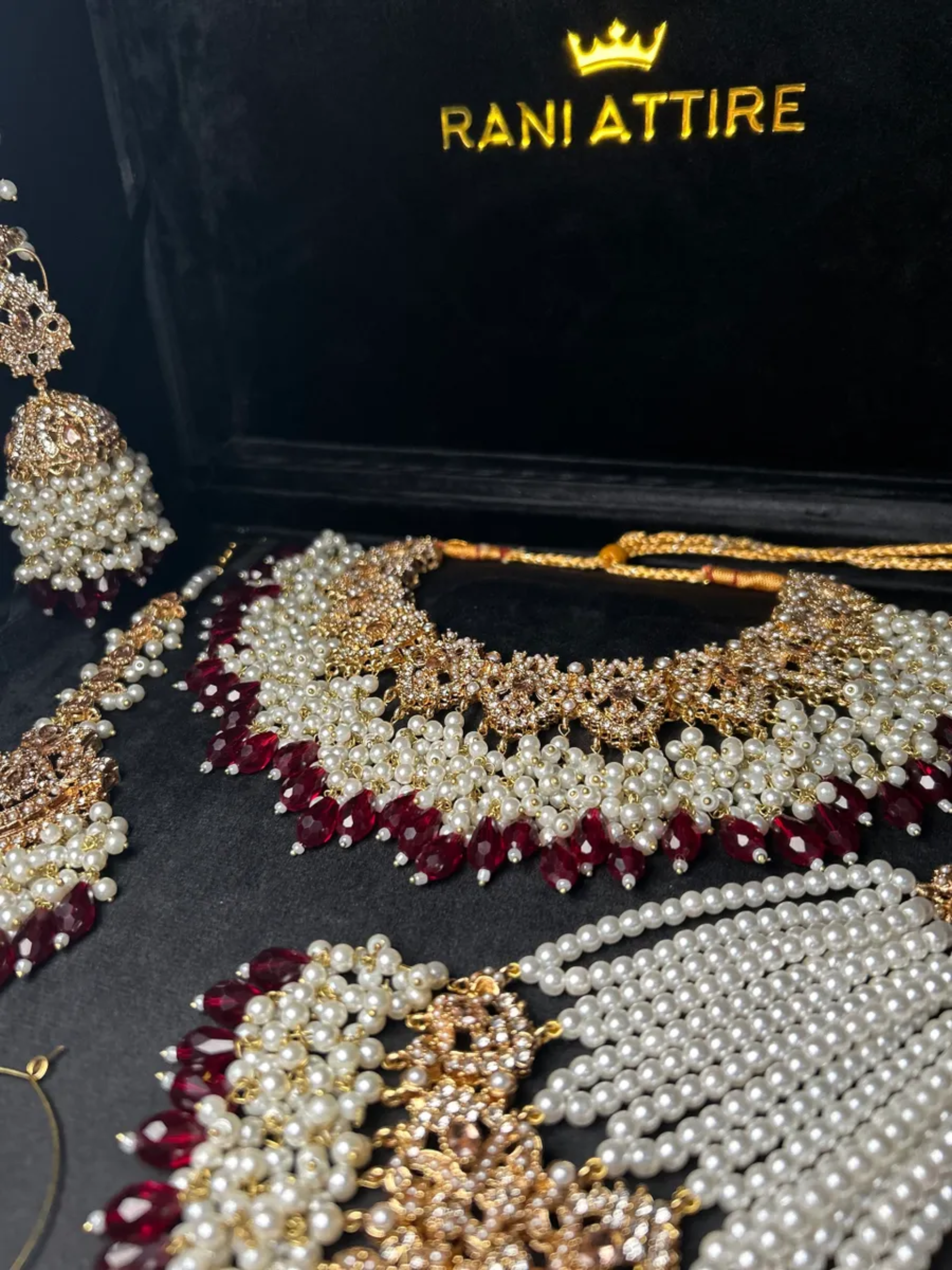 Gold and white necklace with Maroon Crystals + Gold Stones, with heavily beaded earrings & tikka - Jewelsbyrani