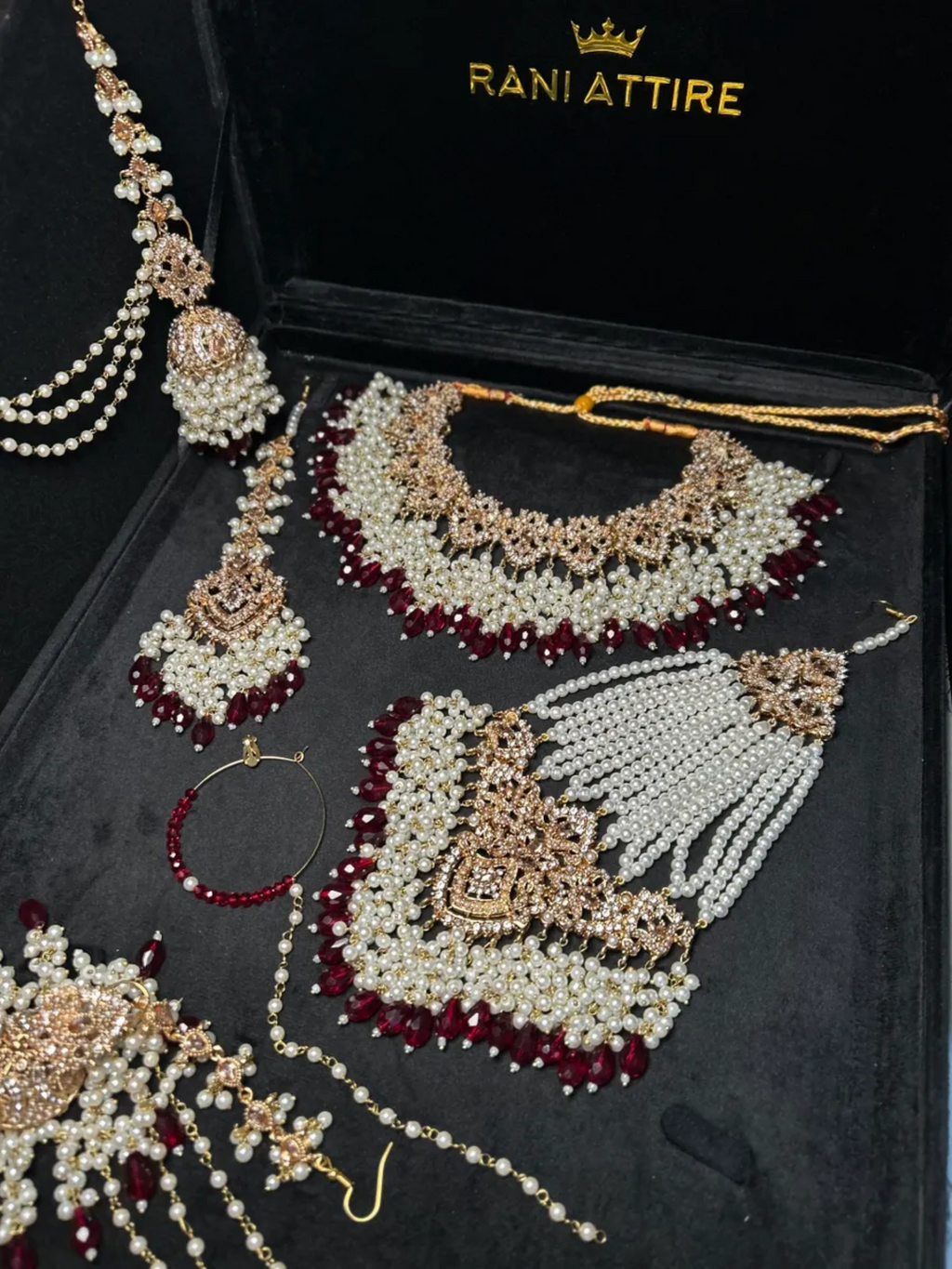 Gold and white necklace with Maroon Crystals + Gold Stones, with heavily beaded earrings & tikka - Jewelsbyrani