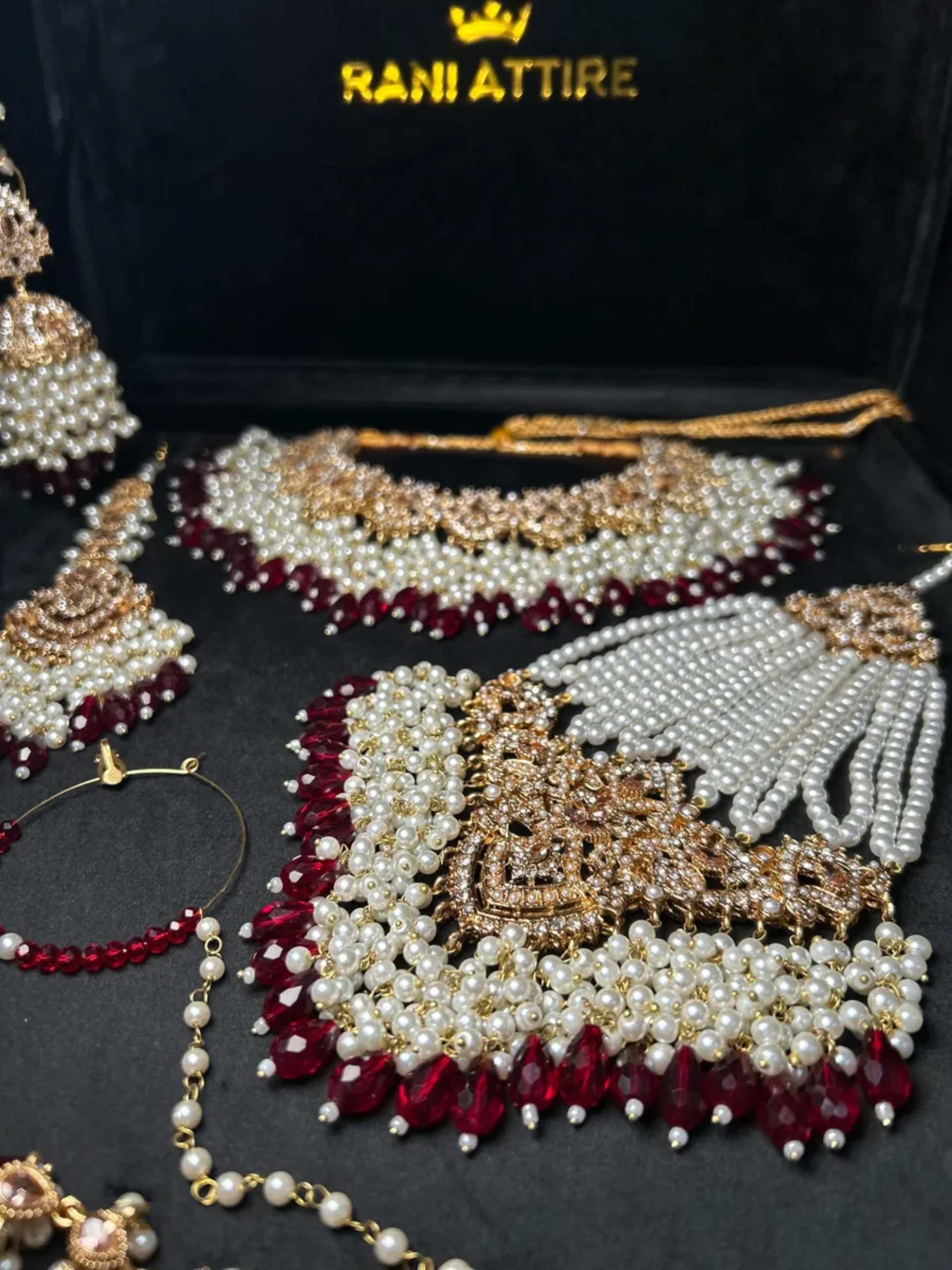 Gold and white necklace with Maroon Crystals + Gold Stones, with heavily beaded earrings & tikka - Jewelsbyrani