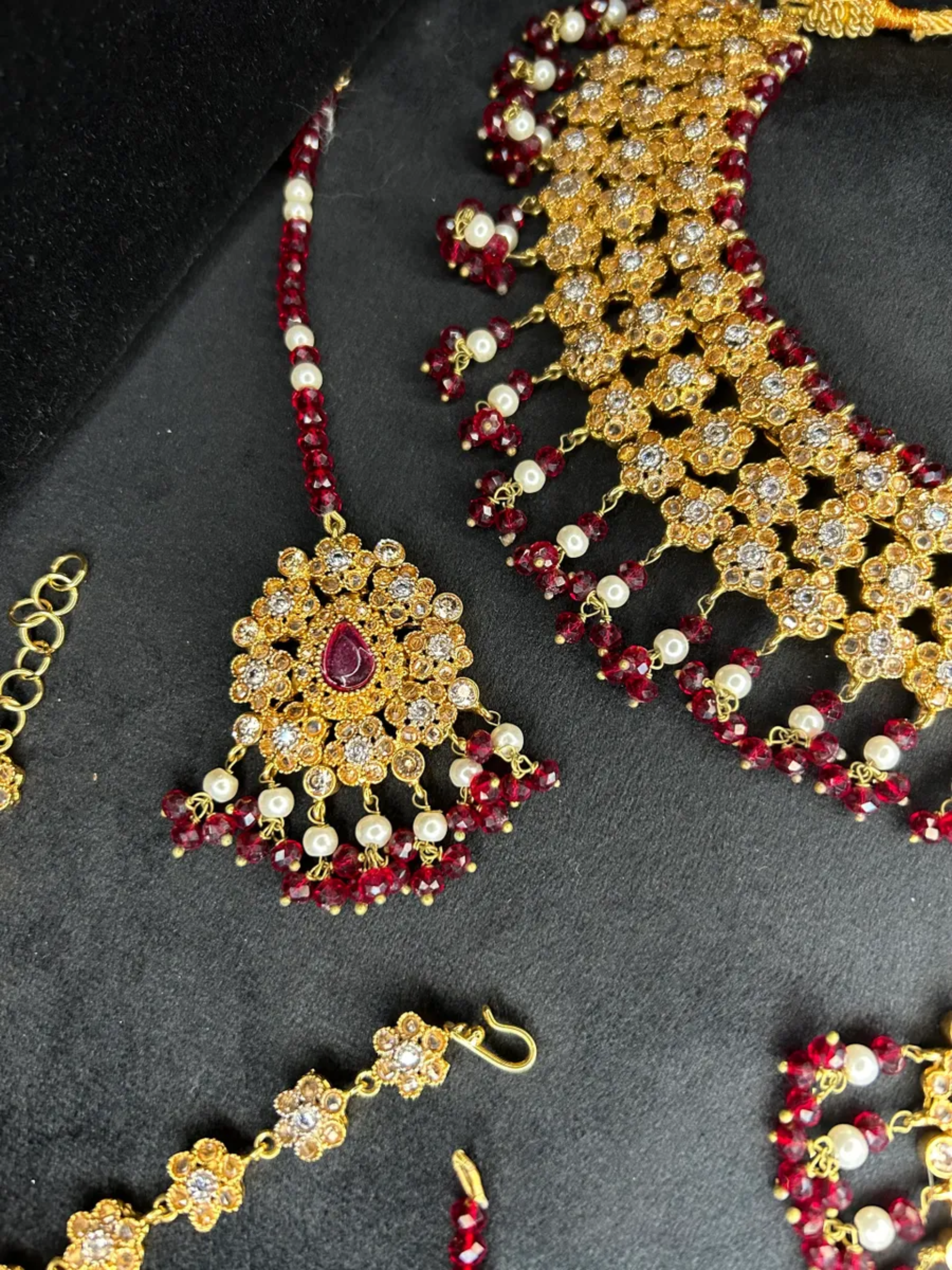 Gold & Maroon set, with heavily beaded jhumkies & tikka.