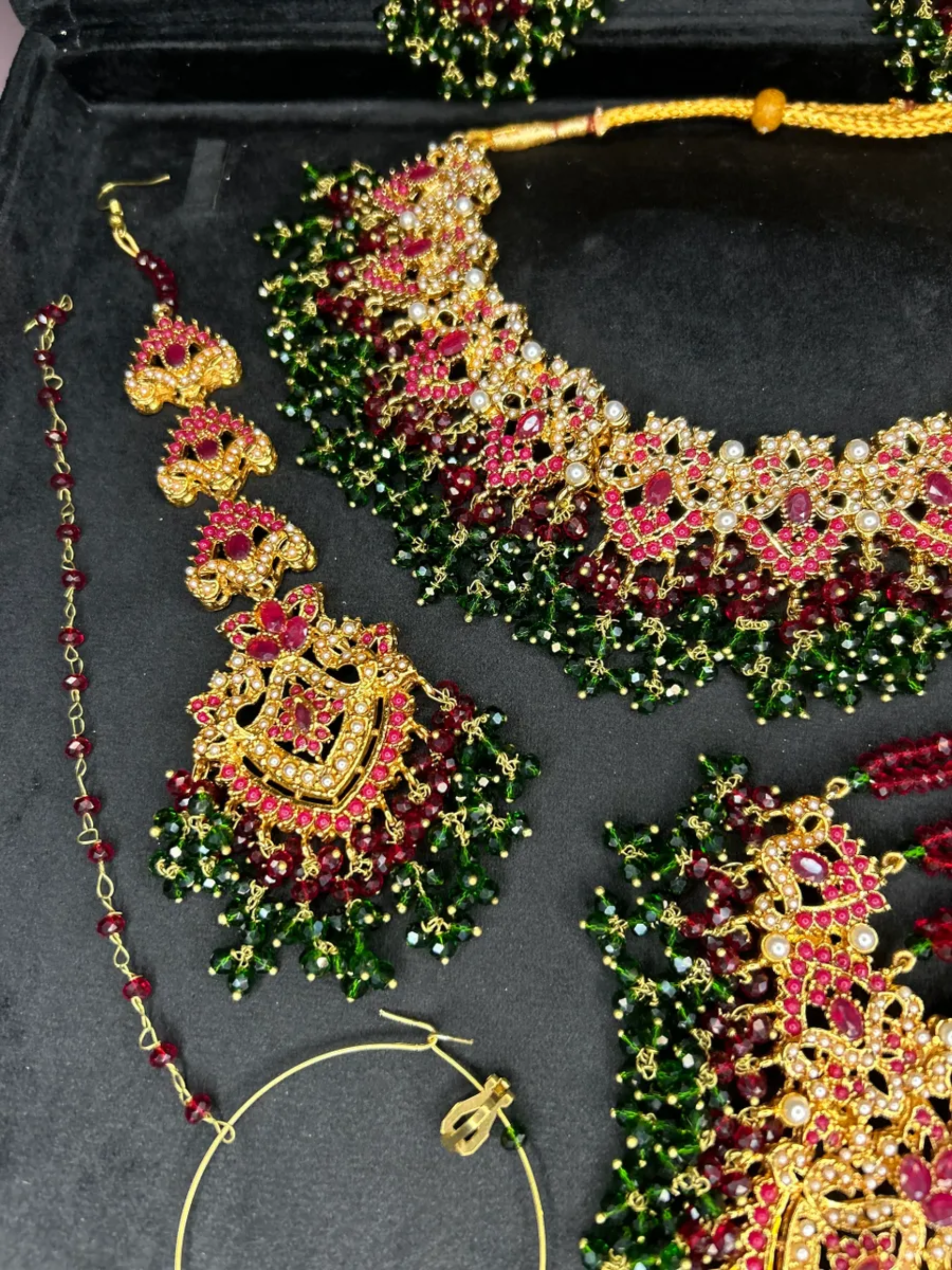 Gold,Green & Maroon set, with heavily beaded jhumkies & tikka.